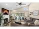 Cozy living room features a fireplace, and expansive sliding glass doors opening to the backyard pool and patio area at 6732 W Sack Dr, Glendale, AZ 85308