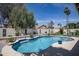 Inviting backyard pool featuring manicured landscaping, a white textured privacy wall, and a refreshing atmosphere at 6732 W Sack Dr, Glendale, AZ 85308