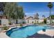 Backyard pool featuring manicured landscaping, a white textured privacy wall, and a refreshing atmosphere at 6732 W Sack Dr, Glendale, AZ 85308