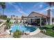 Backyard pool with a covered patio, comfortable lounge chairs, lush landscaping, and a relaxing ambiance at 6732 W Sack Dr, Glendale, AZ 85308