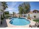 Inviting backyard pool surrounded by lush landscaping and a decorative white wall at 6732 W Sack Dr, Glendale, AZ 85308