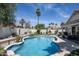 Inviting backyard pool featuring manicured landscaping, a white textured privacy wall, and a refreshing atmosphere at 6732 W Sack Dr, Glendale, AZ 85308