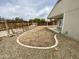 Large backyard with gravel landscaping, framed by a wooden fence and a covered patio, offering a private outdoor space at 7026 S 40Th Pl, Phoenix, AZ 85042