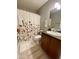 Cozy bathroom featuring a shower with a floral curtain, updated vanity, and neutral color scheme at 7026 S 40Th Pl, Phoenix, AZ 85042