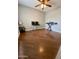 Bedroom with hardwood floors, ceiling fan, and versatile space for customization and comfort at 7026 S 40Th Pl, Phoenix, AZ 85042