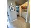 Bright laundry area with stacked washer and dryer unit, tile flooring, and shelving for easy organization at 7026 S 40Th Pl, Phoenix, AZ 85042