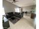 Spacious living room with tile floors, a ceiling fan, and an oversized comfy couch at 7026 S 40Th Pl, Phoenix, AZ 85042