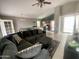 Inviting living room featuring tile floors, a large couch, and natural light at 7026 S 40Th Pl, Phoenix, AZ 85042