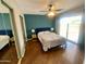 Inviting main bedroom features a ceiling fan, hardwood floors, and access to a private patio at 7026 S 40Th Pl, Phoenix, AZ 85042