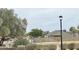Serene street view with lush greenery and a charming lamppost for evening strolls at 7026 S 40Th Pl, Phoenix, AZ 85042