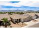 Beautiful aerial view highlighting the home, lush landscaping, and stunning mountain views in the distance at 7241 W Donner Dr, Laveen, AZ 85339