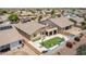 Aerial view of a home with a backyard featuring an artificial lawn, patio and play area at 7241 W Donner Dr, Laveen, AZ 85339