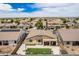 Expansive aerial view showcasing the backyard and the surrounding neighborhood homes on a sunny day at 7241 W Donner Dr, Laveen, AZ 85339
