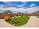 Beautiful backyard featuring a playground, basketball court, and artificial grass at 7241 W Donner Dr, Laveen, AZ 85339