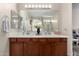 Bathroom showcasing double sink vanity with large mirror and vanity lighting at 7241 W Donner Dr, Laveen, AZ 85339
