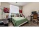Cozy bedroom with a work space and a bed with a green patterned comforter at 7241 W Donner Dr, Laveen, AZ 85339