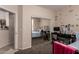 A cozy bedroom is reflected in mirrored closet doors with a desk and floral wall decor at 7241 W Donner Dr, Laveen, AZ 85339