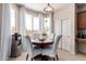 Bright dining area with mountain view features a table, chairs, and stainless steel water cooler at 7241 W Donner Dr, Laveen, AZ 85339