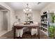 Dining room features a decorative chandelier, table with seating and a grey bookshelf at 7241 W Donner Dr, Laveen, AZ 85339