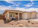 Charming single-story home with a well-manicured lawn, a two-car garage, and a covered front porch at 7241 W Donner Dr, Laveen, AZ 85339