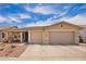 Charming single-story home with a well-manicured lawn, a two-car garage, and a covered front porch at 7241 W Donner Dr, Laveen, AZ 85339