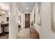 Inviting entryway with neutral tones, tiled flooring, a wooden door, and decorative mirrors at 7241 W Donner Dr, Laveen, AZ 85339