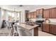 Kitchen with stainless appliances, granite countertops, and adjacent breakfast nook with natural light at 7241 W Donner Dr, Laveen, AZ 85339