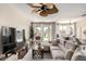 Bright living room with a plush sofa, large windows, and views of the backyard at 7241 W Donner Dr, Laveen, AZ 85339