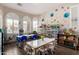 Bright playroom with tables, chairs, storage shelves, and decorative floral wall stickers at 7241 W Donner Dr, Laveen, AZ 85339