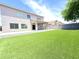 Expansive backyard with artificial grass, a covered patio, and a block wall at 733 E Megan Dr, San Tan Valley, AZ 85140