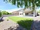 Large backyard with lush artificial grass, desert landscaping, and covered patio at 733 E Megan Dr, San Tan Valley, AZ 85140