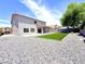 Wide shot of backyard with desert landscaping, lush turf, and an outdoor living area at 733 E Megan Dr, San Tan Valley, AZ 85140