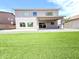 Backyard view with lush turf, desert landscaping, and covered patio at 733 E Megan Dr, San Tan Valley, AZ 85140