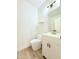 Clean bathroom with white vanity, toilet, and gold fixtures at 733 E Megan Dr, San Tan Valley, AZ 85140