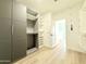 Spacious walk-in closet with custom cabinets, rods, and easy access to bathroom at 733 E Megan Dr, San Tan Valley, AZ 85140
