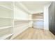 Walk-in closet with custom shelving, drawers, and ample storage space at 733 E Megan Dr, San Tan Valley, AZ 85140