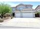 Two-story home featuring a three-car garage, neutral stucco, and drought-resistant landscaping at 733 E Megan Dr, San Tan Valley, AZ 85140
