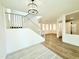 Open foyer with hardwood floors, white walls, staircase, and modern light fixture at 733 E Megan Dr, San Tan Valley, AZ 85140