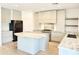 Modern kitchen with a large center island, stainless steel appliances, and a black refrigerator at 733 E Megan Dr, San Tan Valley, AZ 85140