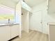 Laundry room with sink, window, and white cabinets with gold fixtures at 733 E Megan Dr, San Tan Valley, AZ 85140