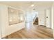 Open-concept living room with wood floors, white walls, and staircase at 733 E Megan Dr, San Tan Valley, AZ 85140