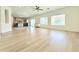 Open concept living room with kitchen in view, and large windows providing natural light at 733 E Megan Dr, San Tan Valley, AZ 85140