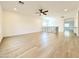Spacious living area with wood floors and a ceiling fan, ideal for relaxation and entertainment at 733 E Megan Dr, San Tan Valley, AZ 85140