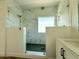 Modern shower with glass enclosure, marble tile, and bronze hardware at 733 E Megan Dr, San Tan Valley, AZ 85140