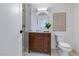 Bathroom featuring a wooden vanity, white toilet, glass enclosed shower, and contemporary decor at 7348 N 9Th Pl, Phoenix, AZ 85020