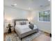 Bright bedroom features a decorative rug, soft gray bed frame, and a window that brings in natural light at 7348 N 9Th Pl, Phoenix, AZ 85020