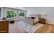 Bright bedroom with natural light, featuring hardwood floors and a stylish decorative rug at 7348 N 9Th Pl, Phoenix, AZ 85020