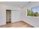 Bright bedroom features a closet with shelves and a window that brings in natural light at 7348 N 9Th Pl, Phoenix, AZ 85020