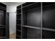 Large, dark walk-in closet with custom shelving, ideal for storing clothes and accessories at 7348 N 9Th Pl, Phoenix, AZ 85020