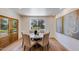 Elegant dining room featuring hardwood floors, natural light, a round table, and stylish artwork at 7348 N 9Th Pl, Phoenix, AZ 85020